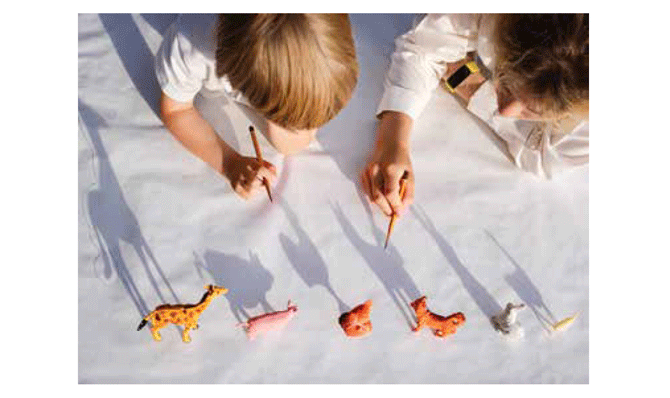 Children looking at shadows of animal toys
