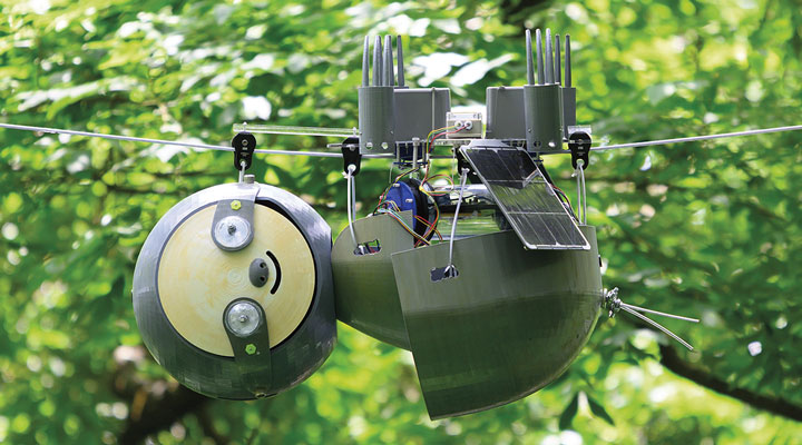 A diagram of a robotic creature with a smile and big eyes, hanging upsidedown on a wire